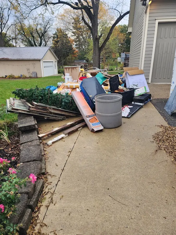 Dumpster being loaded with debris for Estate Cleanout Dumpster Rental in West Little River